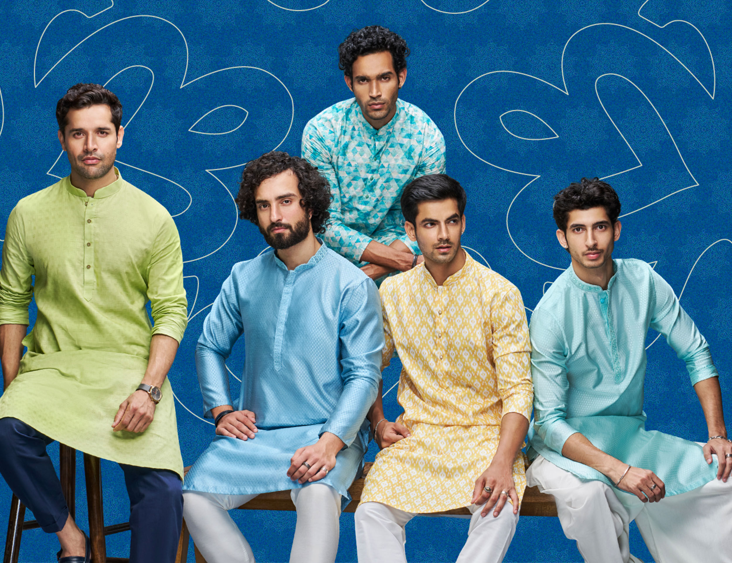 Group of men in colorful traditional kurtas, posing against a vibrant blue backdrop, showcasing stylish Gudi Padwa festive attire.